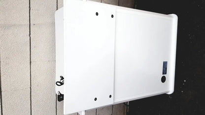 White rectangular outdoor treatment cabinet tc100at with black mounting hardware and a small blue label on right side