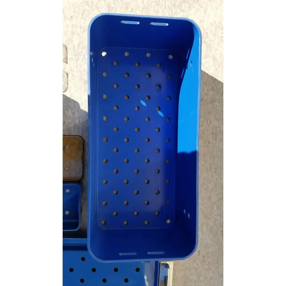 Blue plastic sterilization tray multipak 5006-02-000p with evenly spaced perforations for medical use