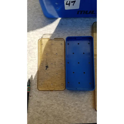 Blue multipak 5006-02-000p plastic sterilization tray with evenly spaced circular holes for medical use