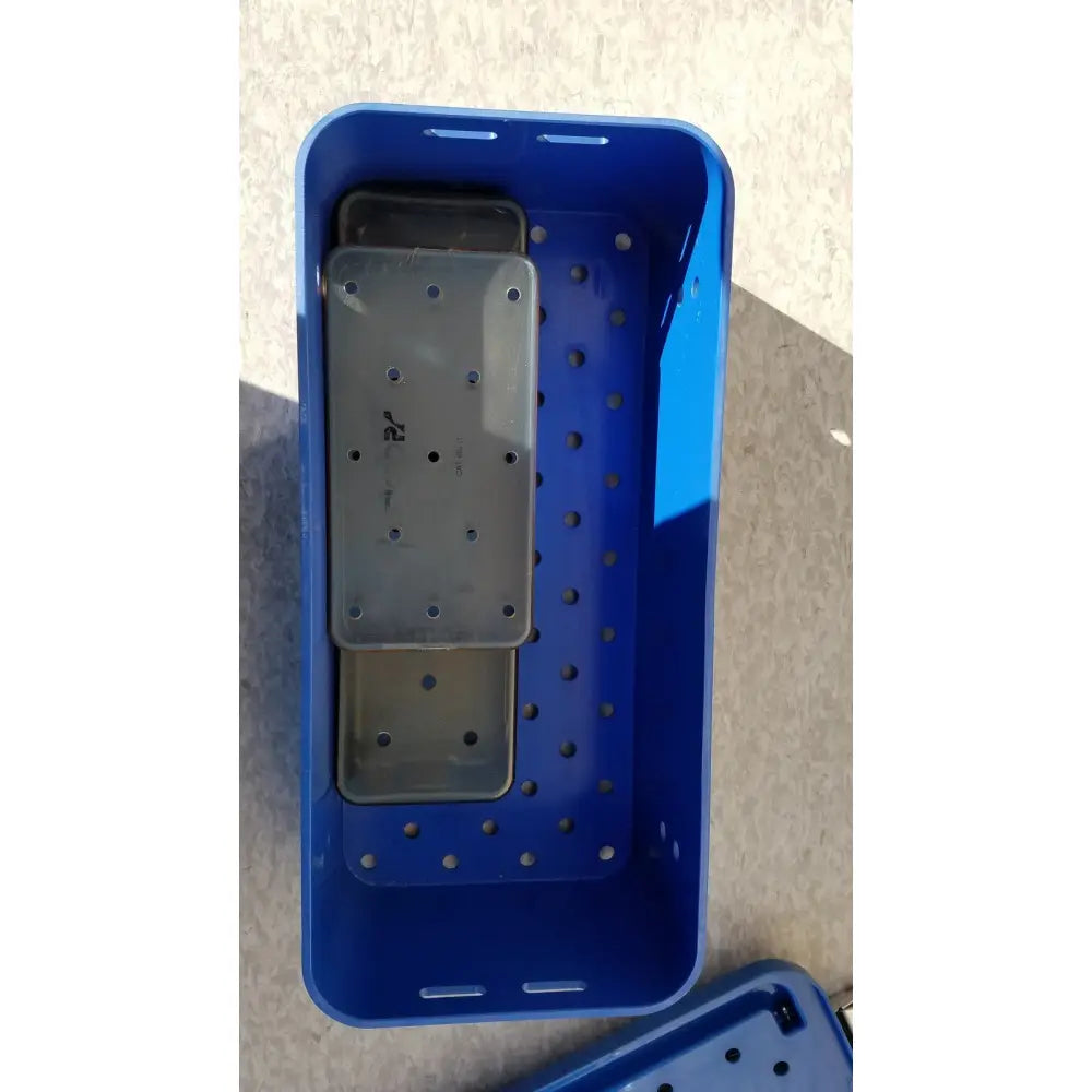 Blue plastic multipak 5006-02-000p sterilization tray with perforated sides and gray rectangular internal tray