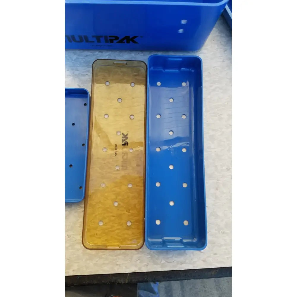 Blue and gold multipak 5006-02-000p plastic sterilization tray with evenly spaced circular holes for medical use