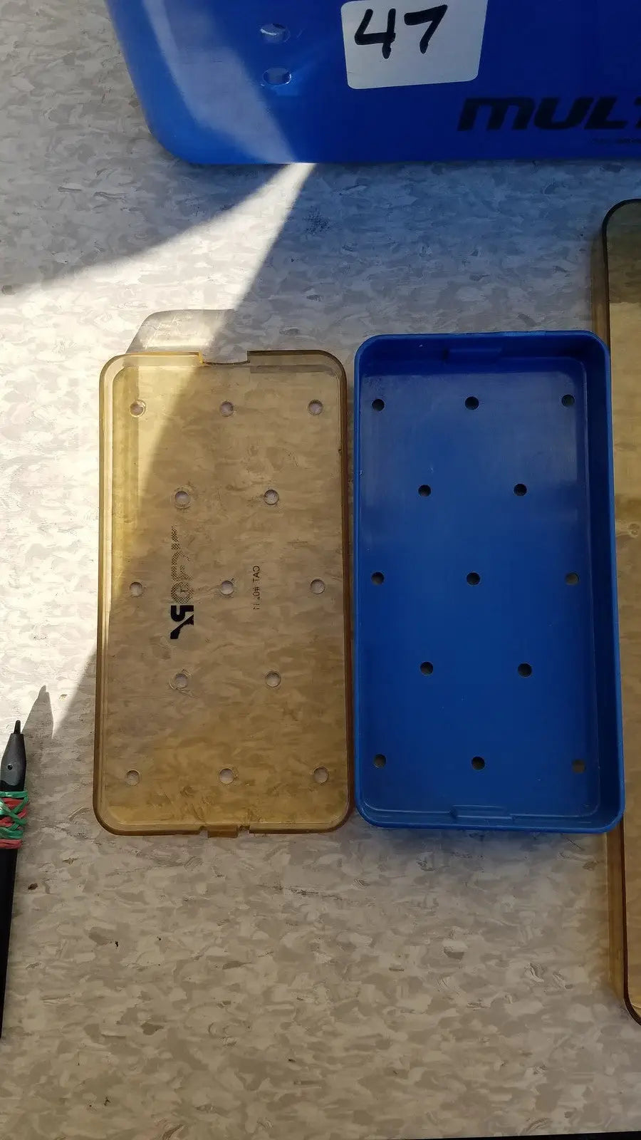 Blue multipak 5006-02-000p plastic sterilization tray with evenly spaced circular holes for medical use