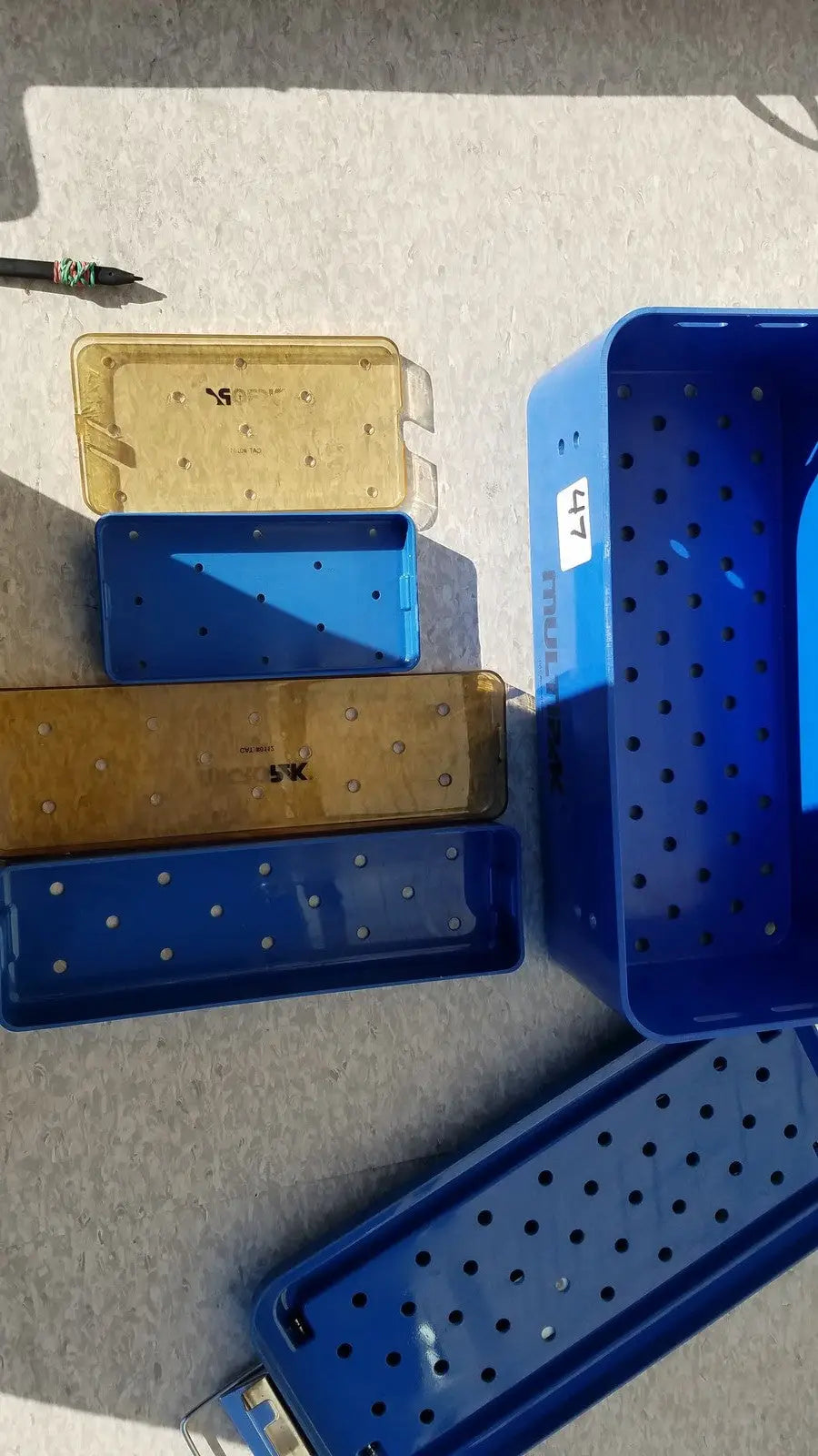Blue plastic sterilization trays with perforated surfaces and labeled compartments multipak 5006-02-000p plastic sterilization tray