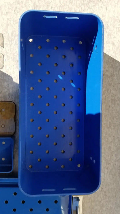Blue plastic sterilization tray multipak 5006-02-000p with evenly spaced perforations for medical use