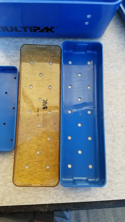 Blue and gold multipak 5006-02-000p plastic sterilization tray with evenly spaced circular holes for medical use