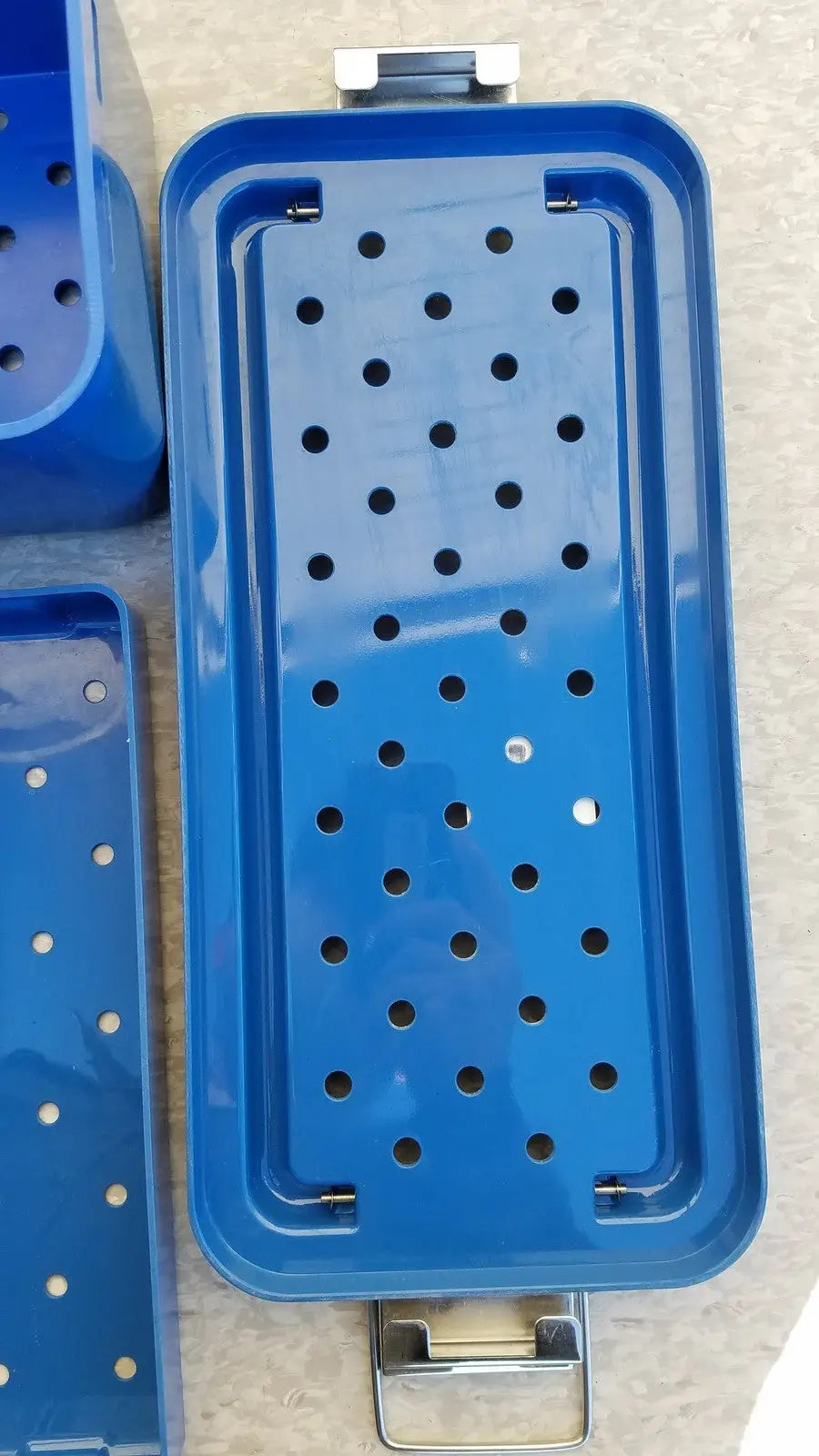 Blue rectangular metal multiPak 5006-02-000p plastic sterilization tray with perforated surface and silver latches