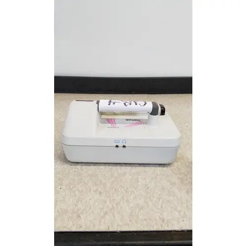 White rectangular medical device with black and white marker on top for natus neurology freedop xld004 use