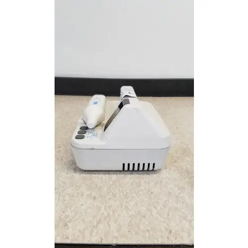 White plastic dental handpiece with black grip and control unit in natus neurology freedop xld004 model