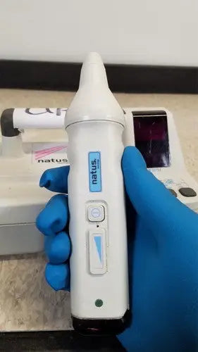 White Natus Neurology Freedop XLD004 otoscope with sleek ergonomic design and blue accent buttons for precise diagnostics