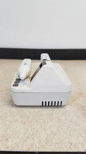 White plastic dental handpiece with black grip and control unit in natus neurology freedop xld004 model