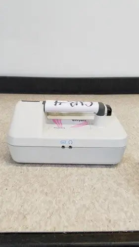 White rectangular medical device with black and white marker on top for natus neurology freedop xld004 use