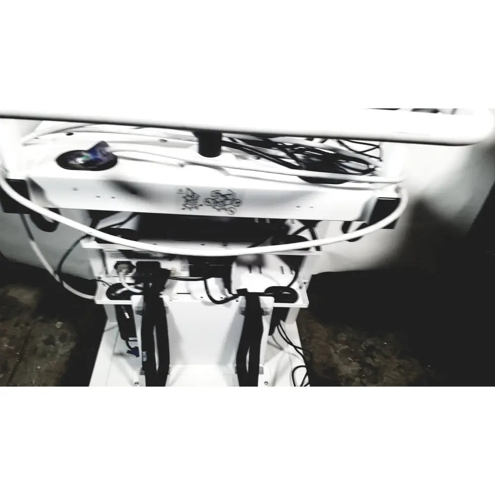 White natus neurology nicolet edx base system with cart showing black cables and blue light component from the back side
