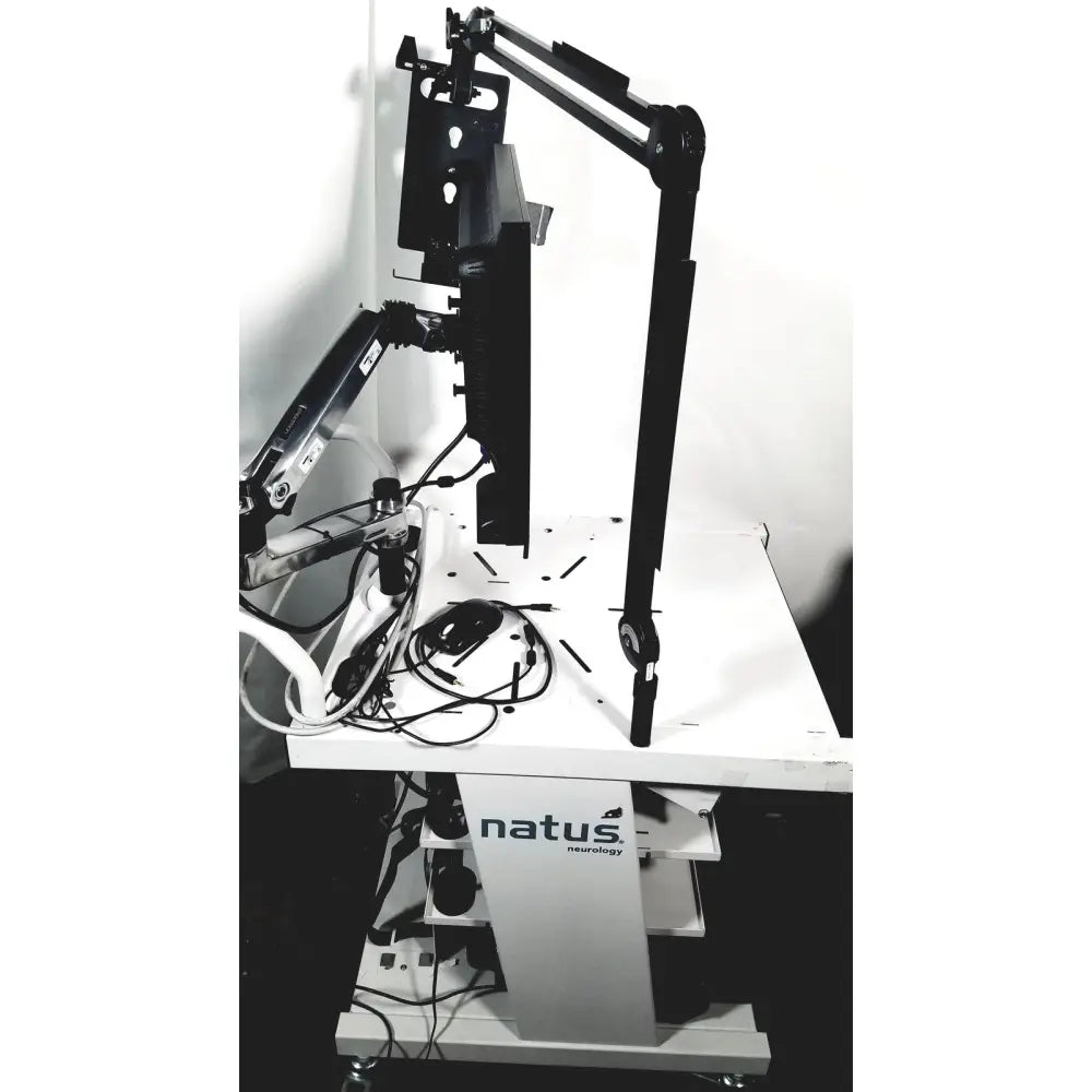 Black articulated arm monitor stand mounted on white mobile cart with natus neurology nicolet edx base system branding