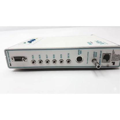 White rectangular natus neurology xltek brain monitor with multiple ports labeled connectors and a small blue button on top left