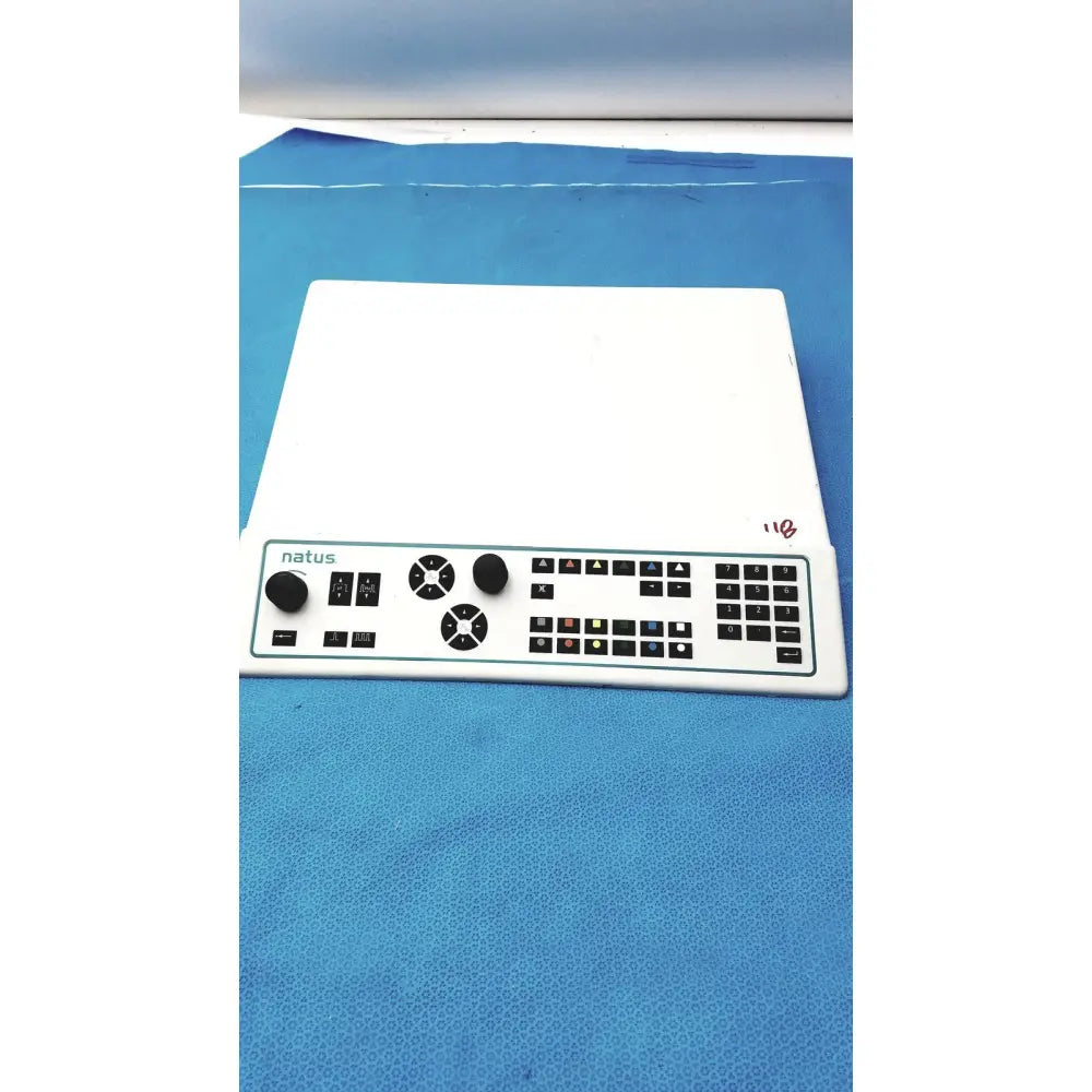 White plastic natus ultrapro s100 unit control panel with black knobs, buttons, and numeric keypad for medical use
