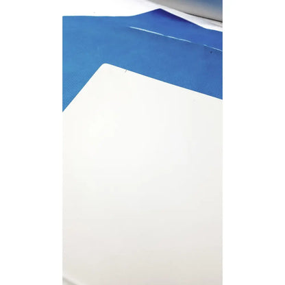White rectangular cutting mat with textured surface on blue film for natus ultrapro s100 unit control panel use