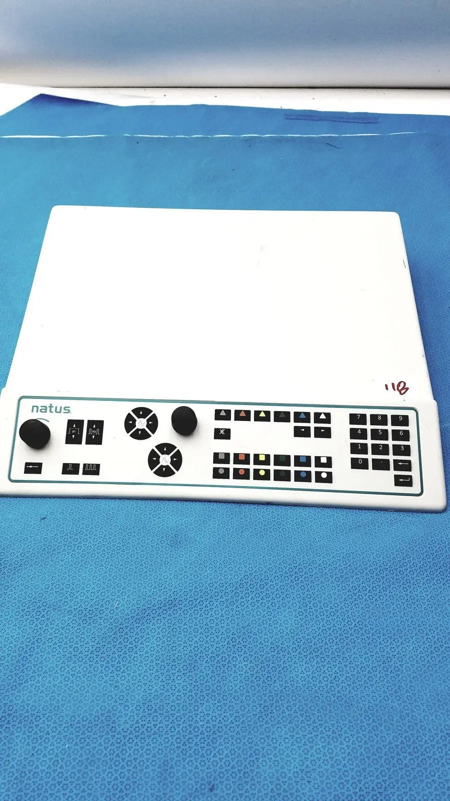 White plastic natus ultrapro s100 unit control panel with black knobs, buttons, and numeric keypad for medical use