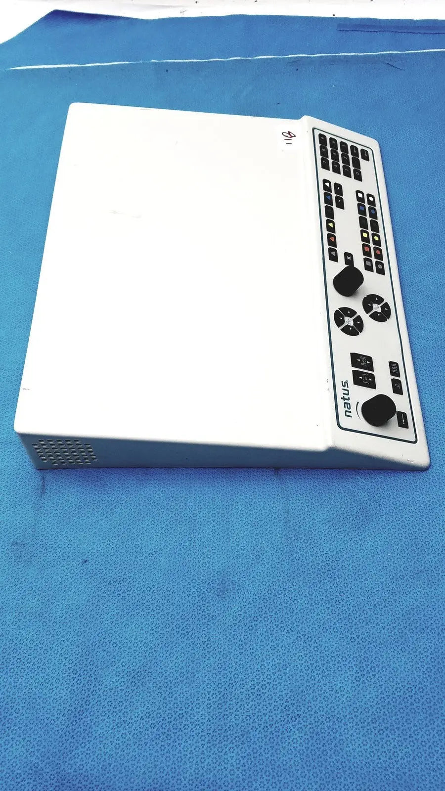 White natus ultrapro s100 unit control panel featuring black buttons knobs and a grid layout for precise audio mixing