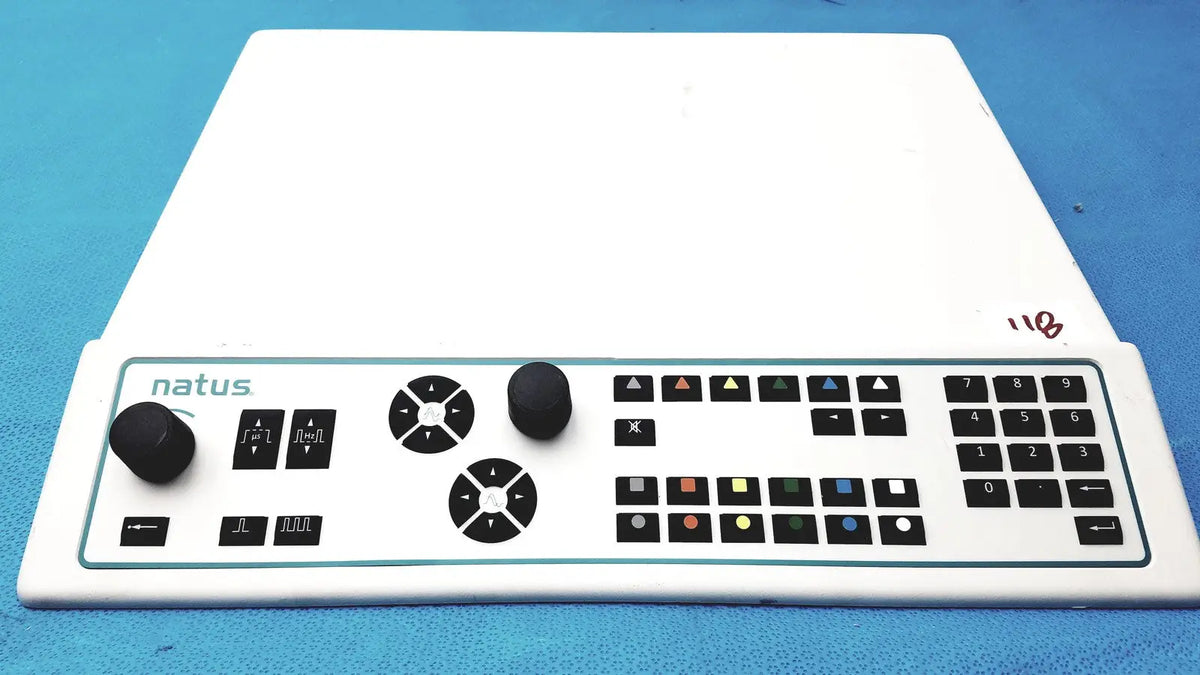 White natus ultrapro s100 unit control panel with black knobs buttons and numeric keypad for video production control