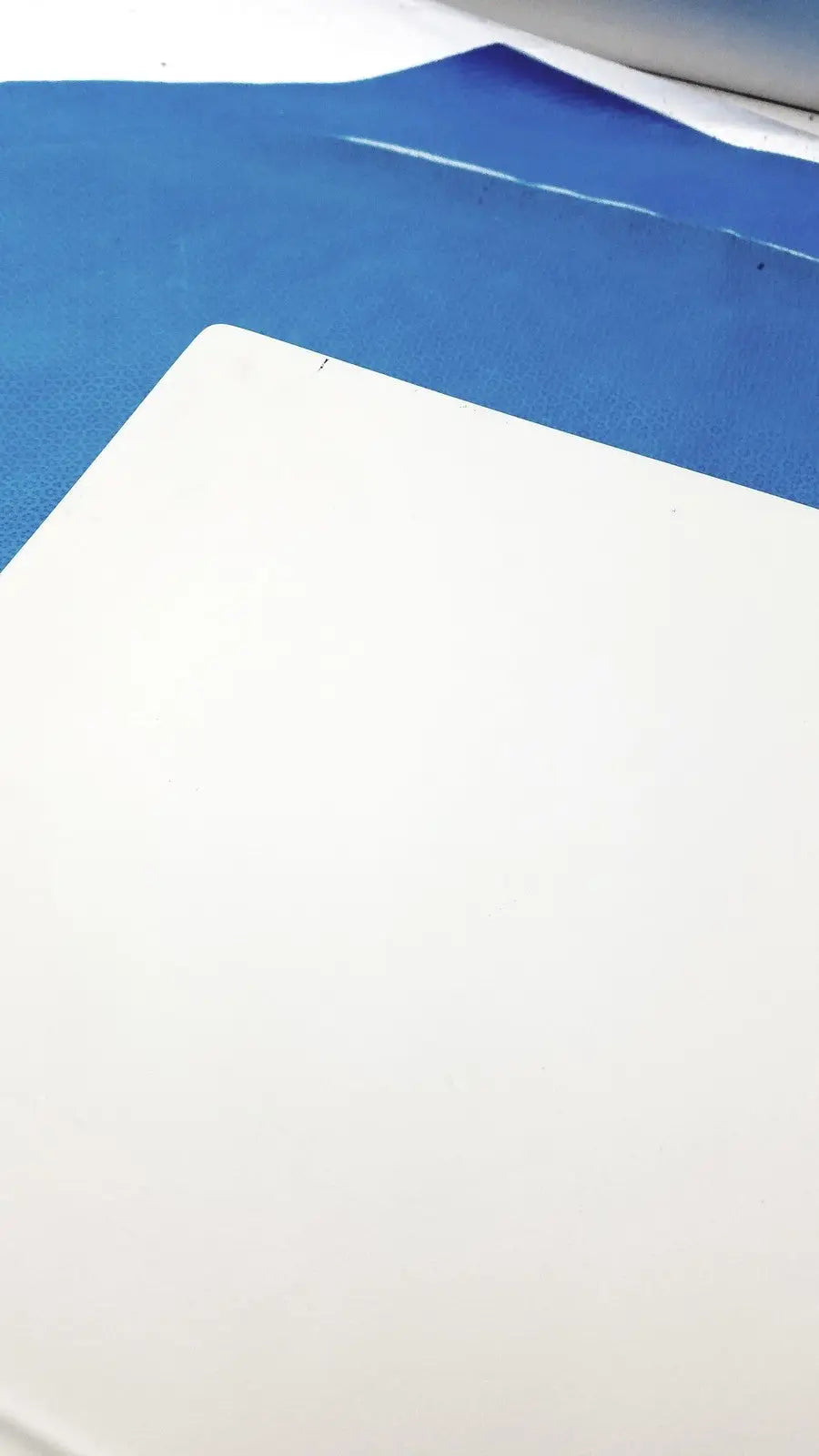 White rectangular cutting mat with textured surface on blue film for natus ultrapro s100 unit control panel use