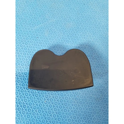 Dark brown smooth rubber spatula with rounded top and curved edges paired with nellcor puritan bennett portable pulse oximeter case