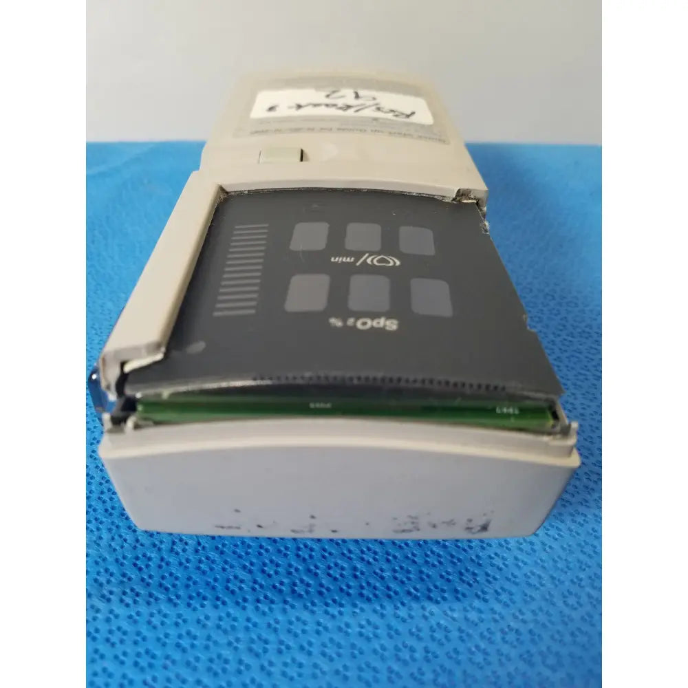 Beige plastic sony sp-10 portable cassette player with black front panel and visible green circuit board for nellcor puritan bennett pulse oximeter case