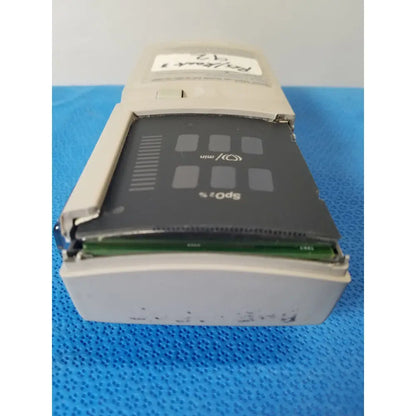 Beige plastic sony sp-10 portable cassette player with black front panel and visible green circuit board for nellcor puritan bennett pulse oximeter case