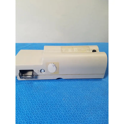 Beige nellcor puritan bennett portable pulse oximeter with circular dial and rectangular port on the side in case