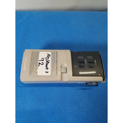 Beige nellcor puritan bennett portable pulse oximeter with black display panel and labeled battery compartment