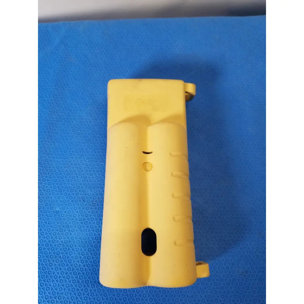 Yellow plastic grip with textured surface and molded contours on nellcor puritan bennett n-20 portable pulse oximeter