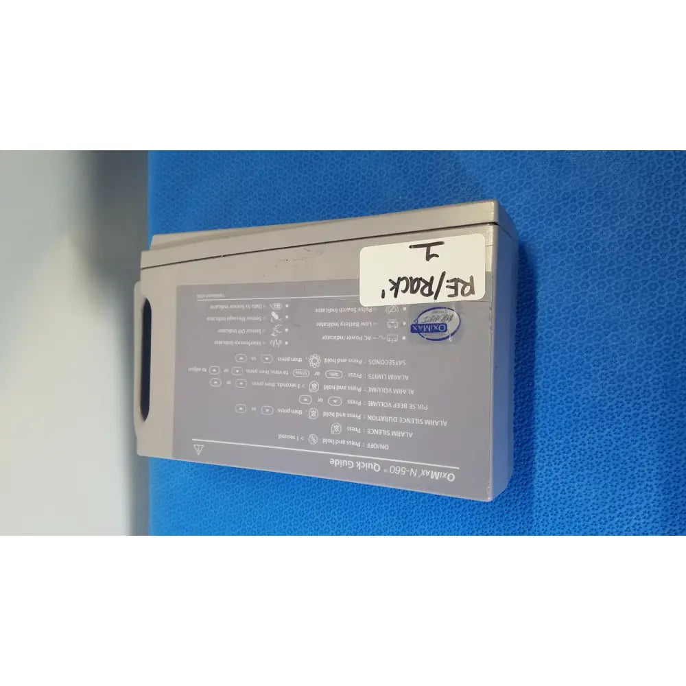 Gray rectangular nellcor puritan bennett puritan bennett oximax pulse oximeter spo2 patient monitor back side with labels