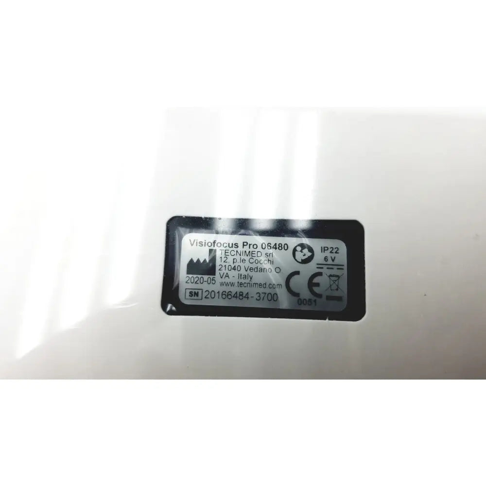 White plastic label with black text showing product information on the back of a visiofocus pro professional non-contact forehead infrared thermometer