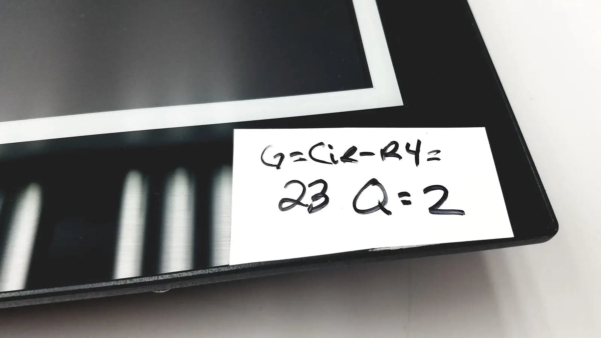 Black rectangular nexcom ippd2100p multimedia panel pc with white label showing handwritten math equations and numbers