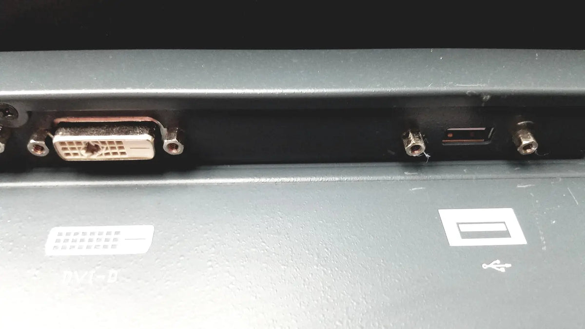 Backside of nexcom ippd2100p multimedia panel pc showing a metallic dvi-d port and screws on dark gray casing