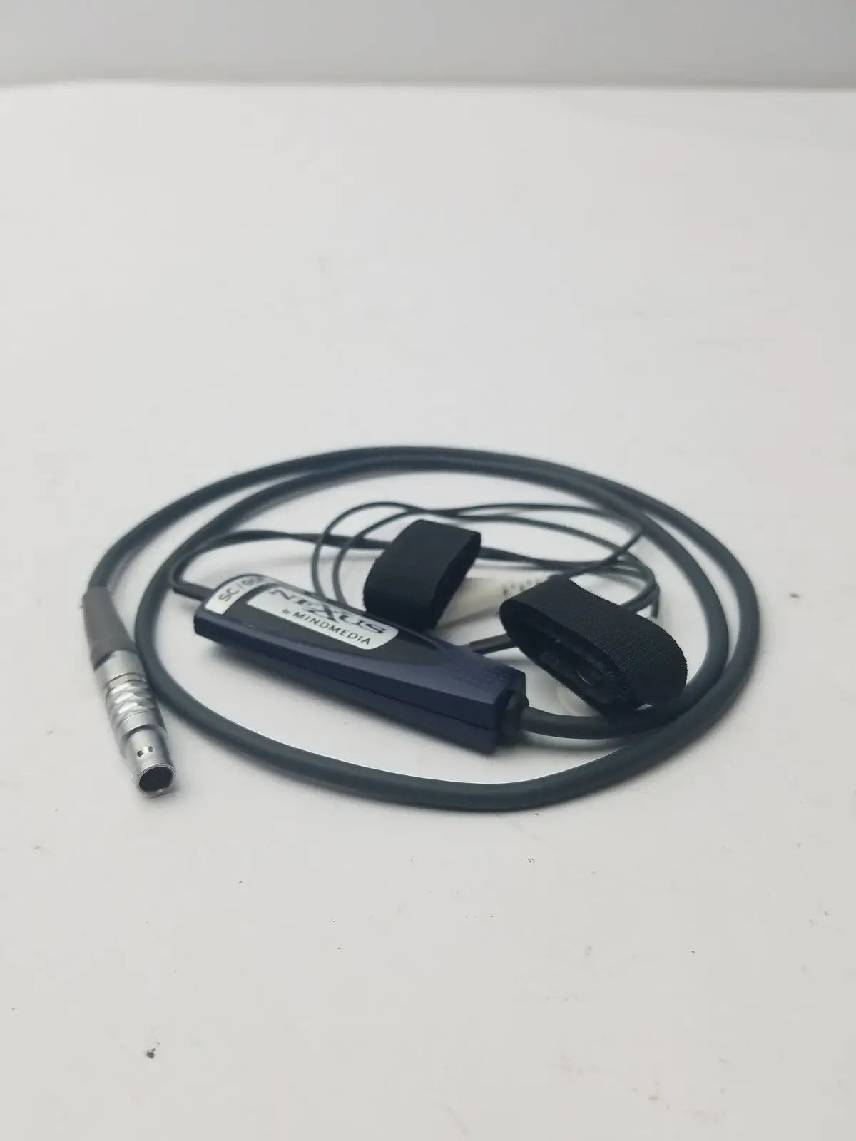Black nexus skin conductance sensor cable with silver connector and two black elastic loops for secure attachment