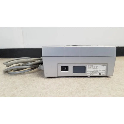 Gray plastic power strip with coiled cords and black switch for nidek ar-20st1 handheld autorefractor printer use