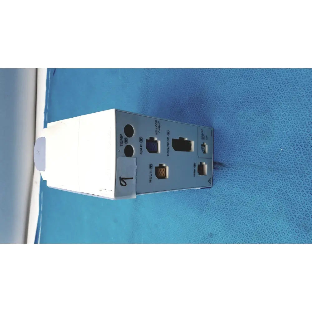 White rectangular nihon kohden ay-651p multi-parameter module showing labeled temp spo2 and ecg ports on back side