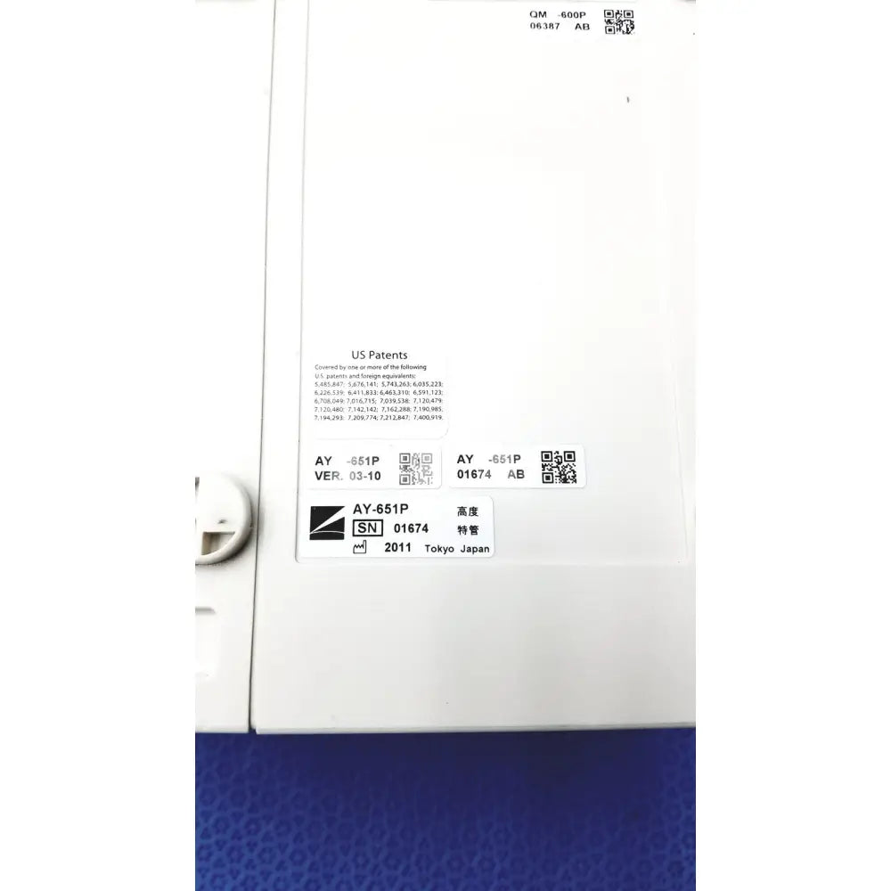 White plastic label with black text and qr codes on the back of nihon kohden ay-651p multi-parameter module