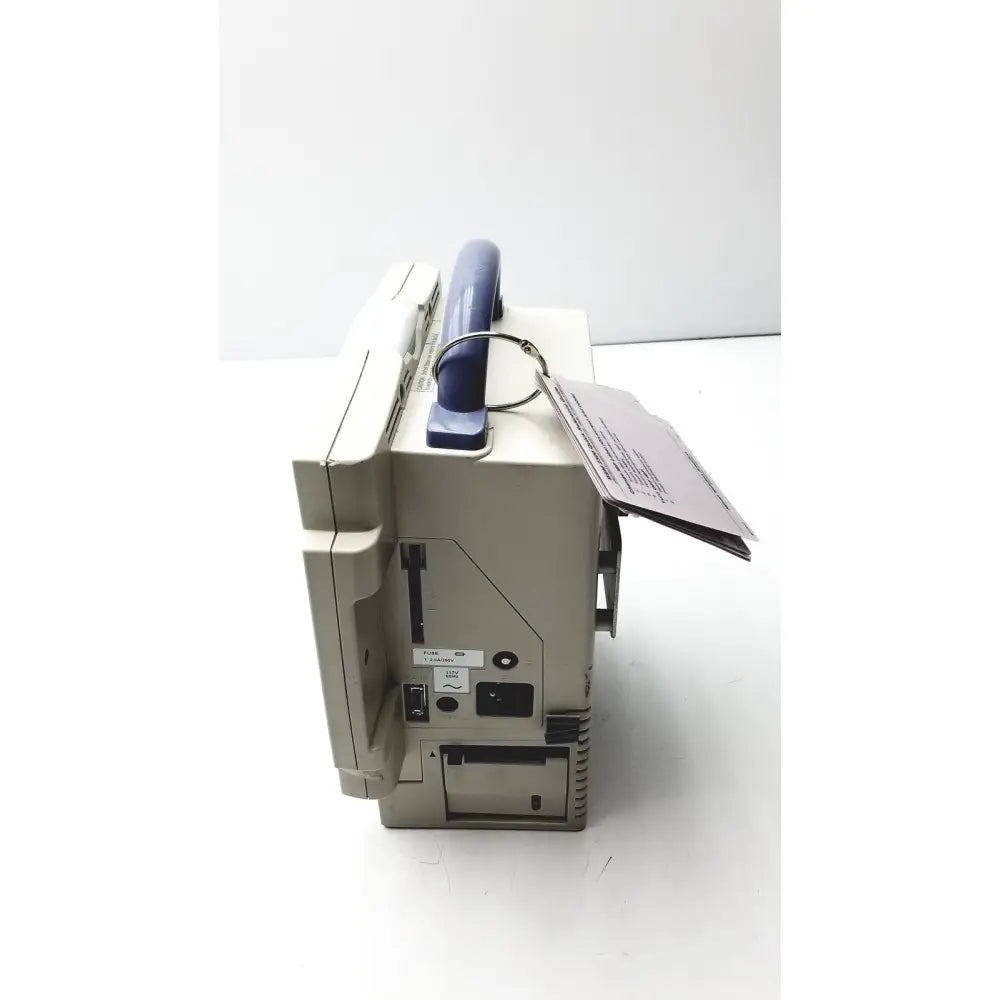 Beige nihon kohden bsm-2351a bedside patient monitor showing the back with blue handle and multiple ports visible