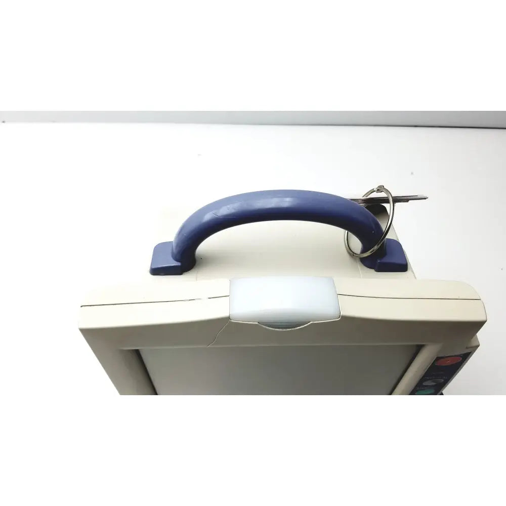 Beige nihon kohden bsm-2351a bedside patient monitor with blue plastic handle and key ring attached for easy portability