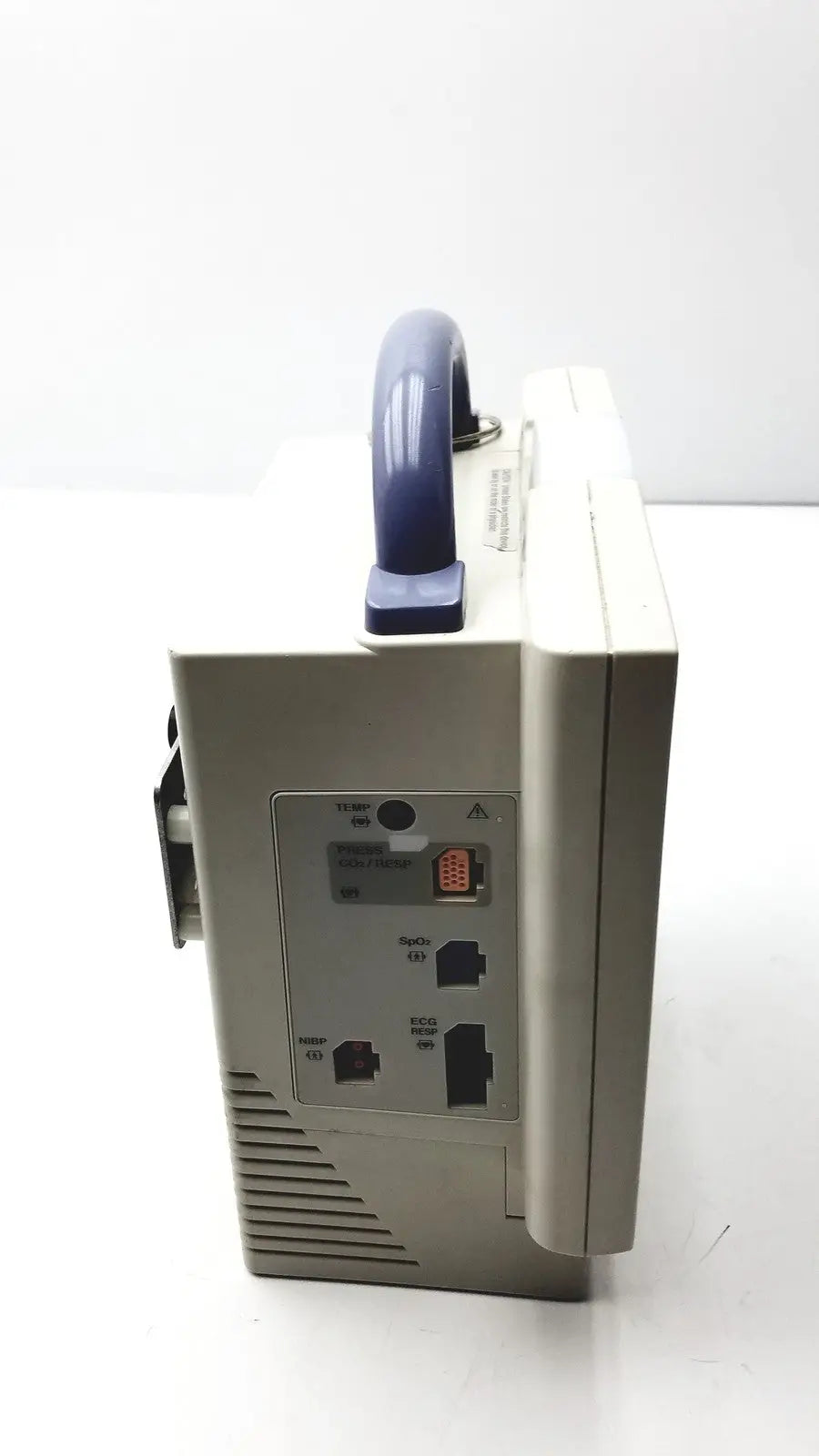 Beige nihon kohden bsm-2351a bedside patient monitor with blue handle and multiple ports on the back side