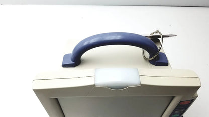 Beige nihon kohden bsm-2351a bedside patient monitor with blue plastic handle and key ring attached for easy portability