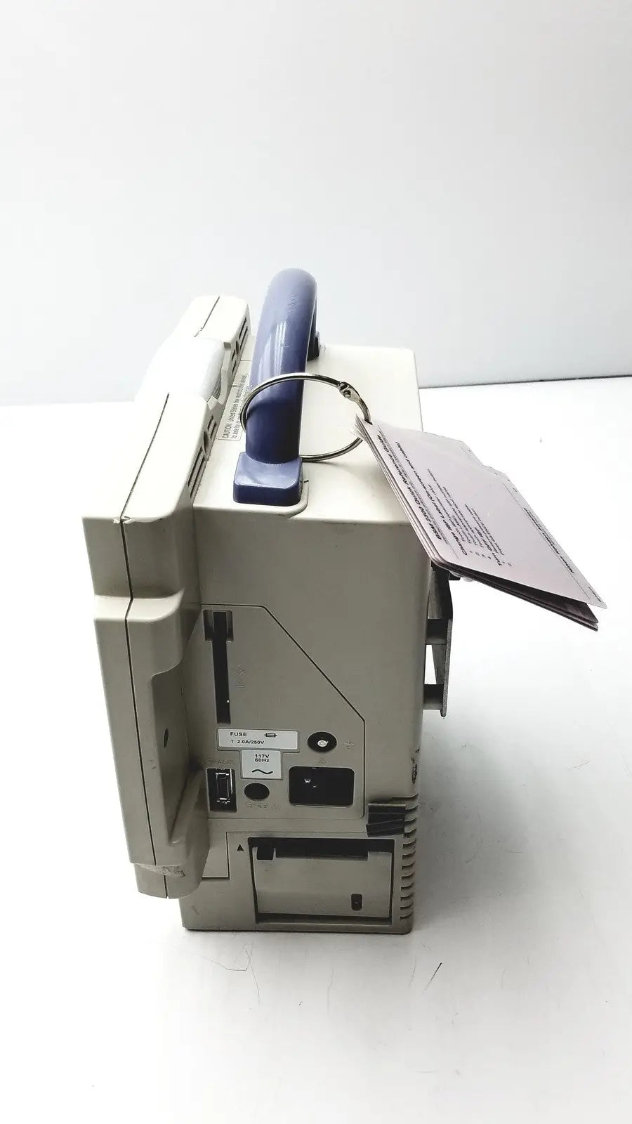 Beige nihon kohden bsm-2351a bedside patient monitor showing the back with blue handle and multiple ports visible