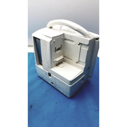 White plastic portable nihon kohden bsm-6501a life scope bedside patient monitor with handle and visible internal components