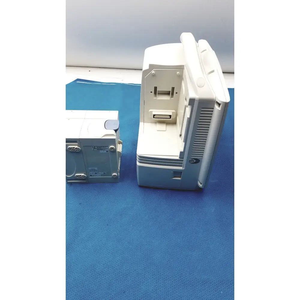 White plastic nihon kohden bsm-6501a life scope bedside patient monitor with rectangular shape and vertical ventilation slits