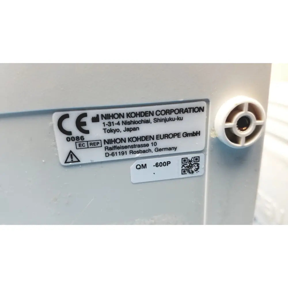 White plastic label with black text showing manufacturer details on the back of nihon kohden life scope bedside patient monitor