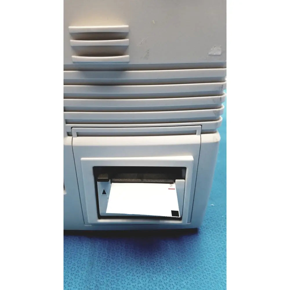 Gray plastic Nihon Kohden life scope bedside patient monitor with horizontal ridged design and paper output tray