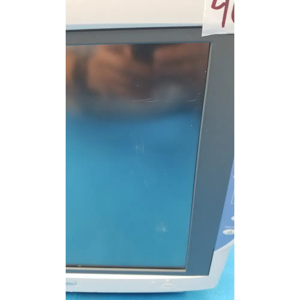 Gray-framed nihon kohden bsm-6701a life scope bedside patient monitor with blue screen and scratched glass display