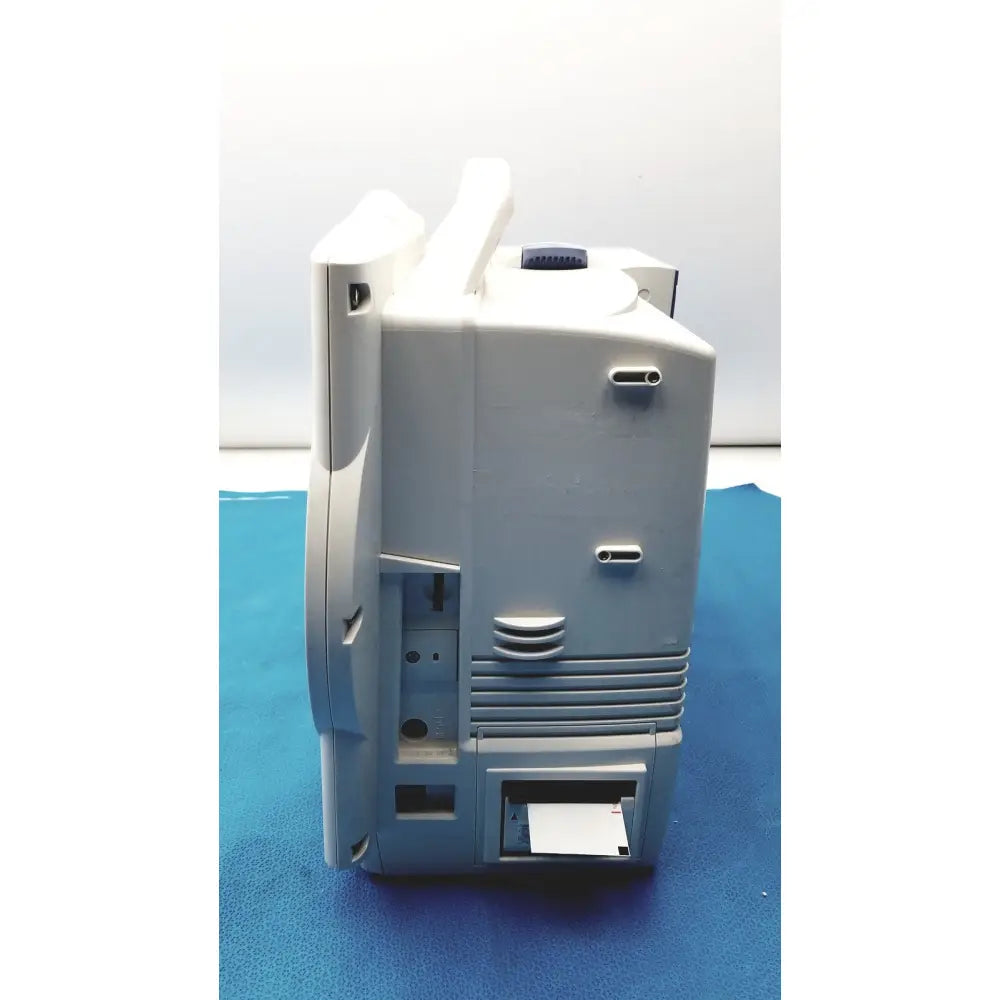 Gray plastic nihon kohden bsm-6701a life scope bedside patient monitor with blue circular knob and ventilation slits along side