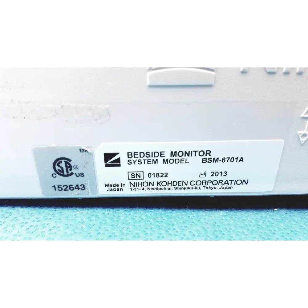White rectangular label on nihon kohden bsm-6701a life scope bedside patient monitor showing model and manufacturer